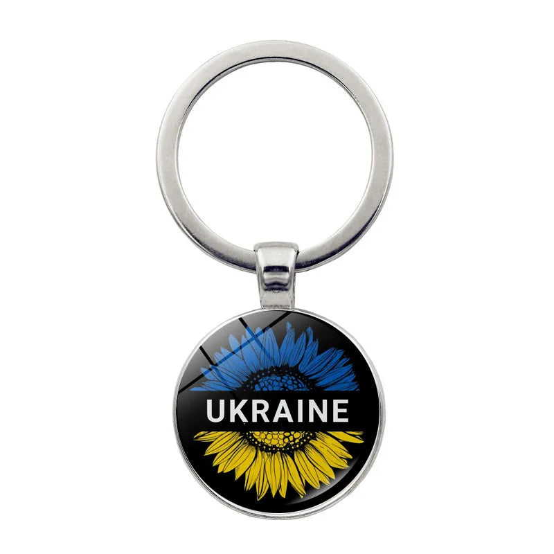 Ukrainian glass keychain with sunflower emblem, showcasing national pride.