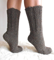 Hand-knitted wool socks made from 100% pure sheep wool, showcasing thick ribbed design, warm and cozy for cold weather.