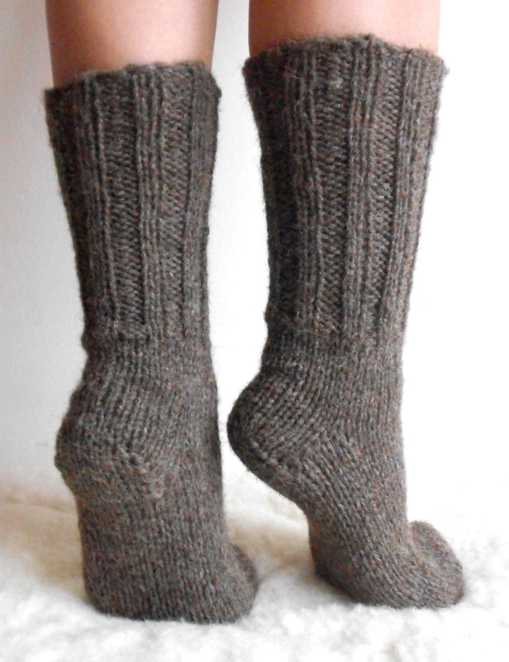 Hand-knitted wool socks made from 100% pure sheep wool, showcasing softness and warmth on feet.