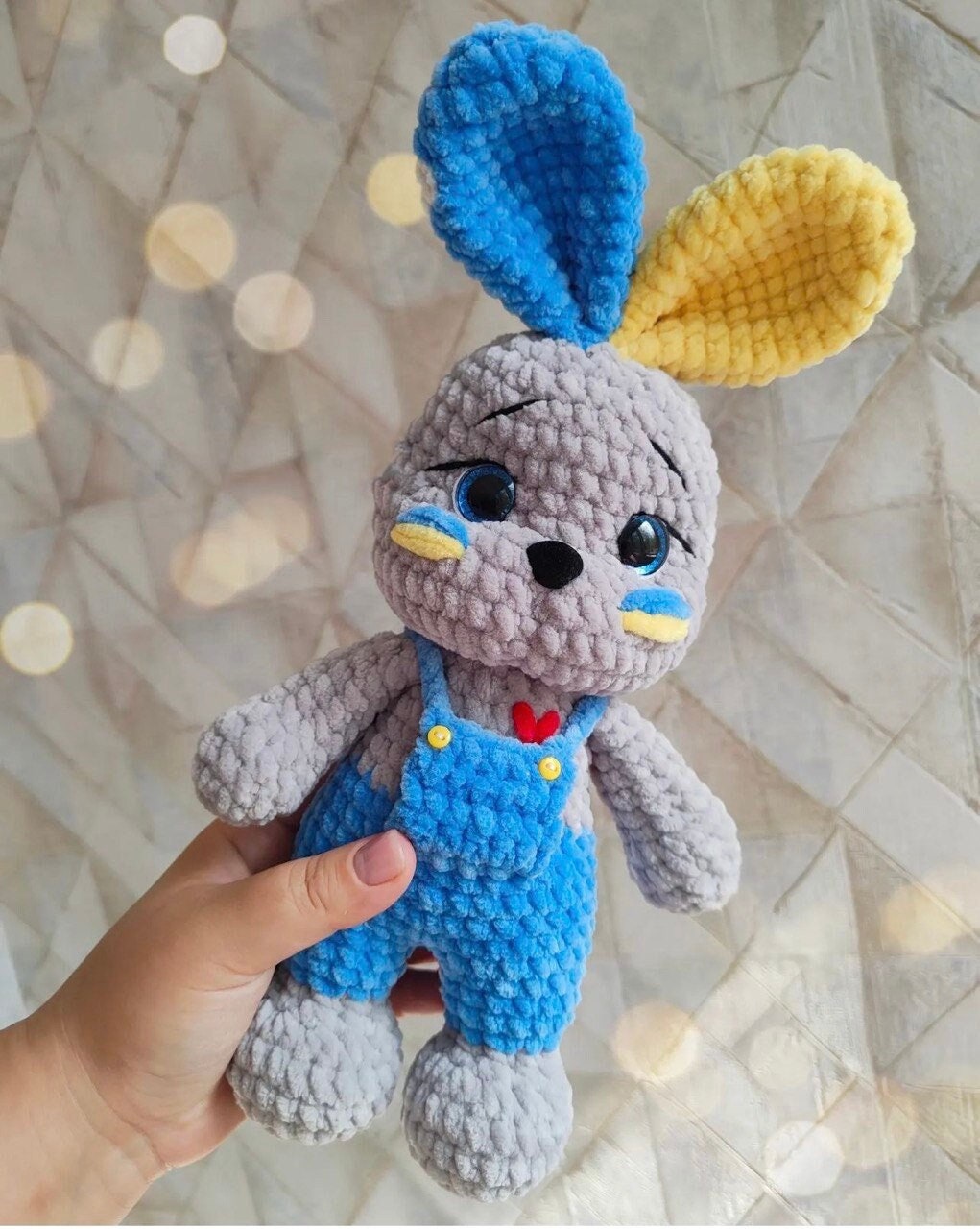 Handmade crochet bunny in Ukrainian flag colors, blue and yellow plush toy, symbol of peace and hope from Ukraine.
