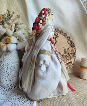 Handmade Motanka doll, traditional Ukrainian talisman, showcasing intricate design and cultural significance on display.