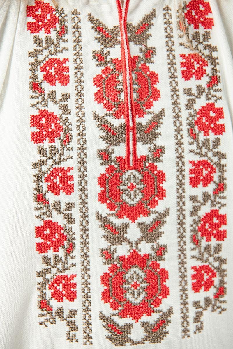 Ukrainian linen shirt with ethnic floral embroidery in milk color, showcasing traditional red and beige designs for girls.