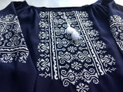 Marsala boho vyshyvanka blouse with intricate white geometric embroidery on dark fabric, featuring classic Ukrainian design.