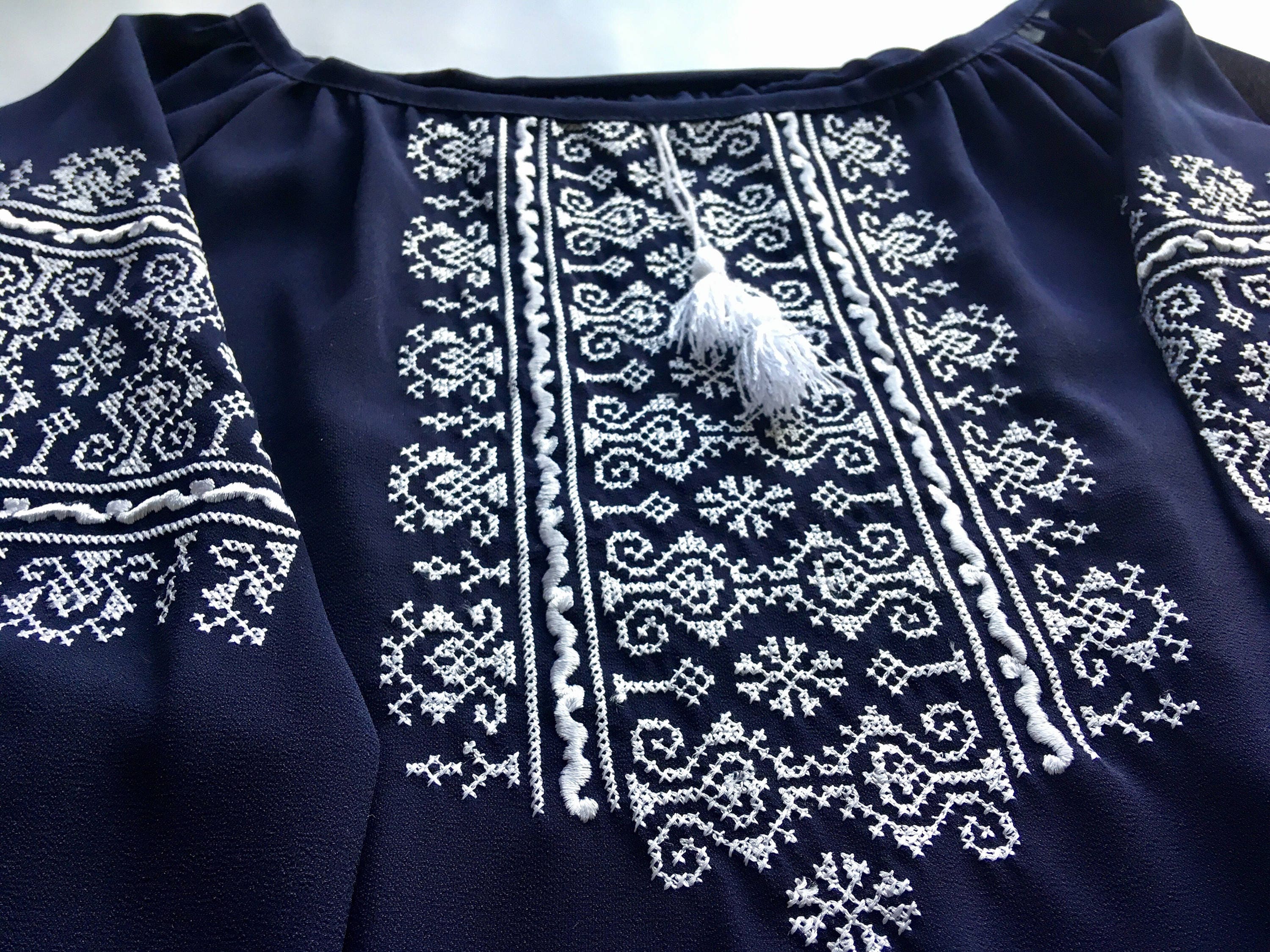 Marsala boho vyshyvanka blouse with intricate white geometric embroidery on dark fabric, featuring classic Ukrainian design.