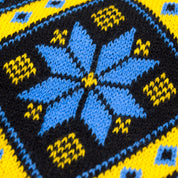 Traditional Ukrainian knit scarf pattern in yellow and blue with geometric ornament, highlighting cozy winter style and heritage.