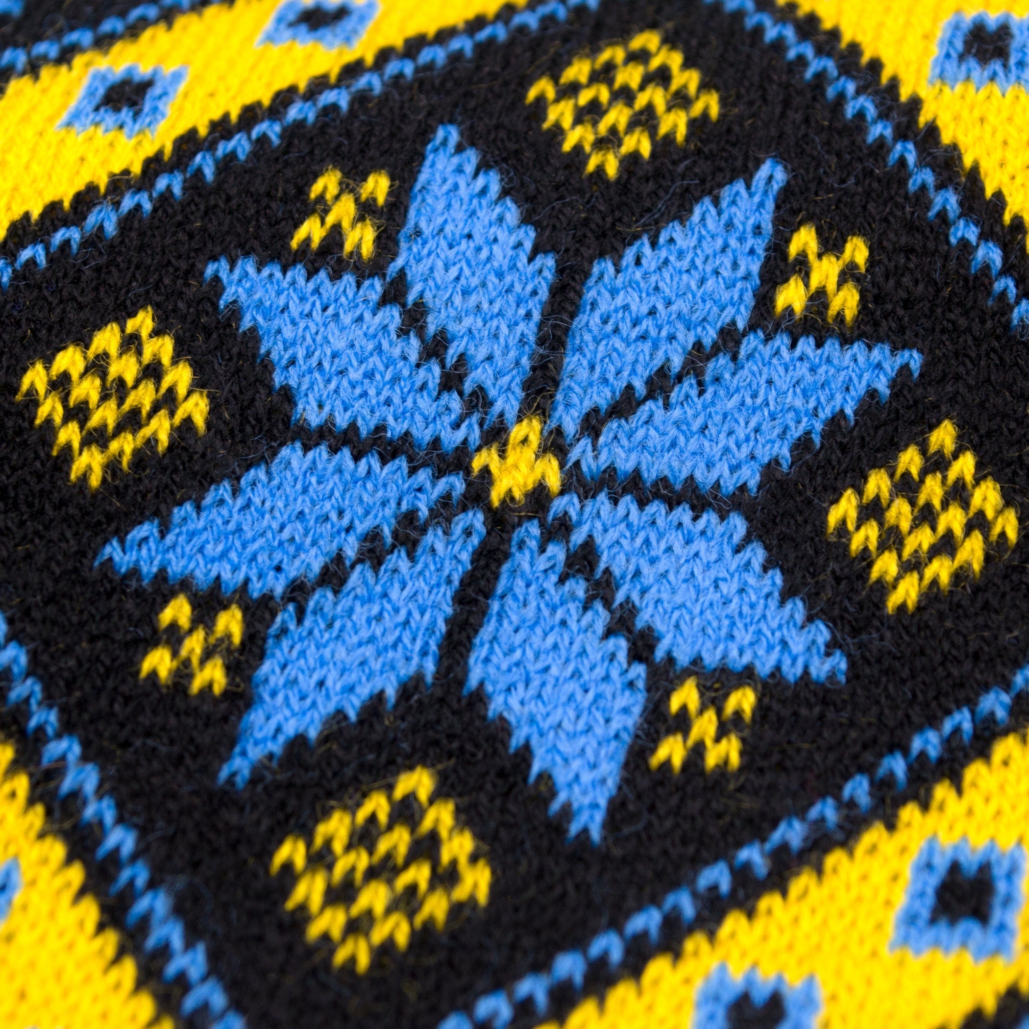 Traditional Ukrainian knit scarf pattern in yellow and blue with geometric ornament, highlighting cozy winter style and heritage.