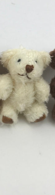 Hand-sewn miniature teddy bear with moveable arms and legs, made from soft fuzzy fabric, perfect for hanging as a cute decoration.