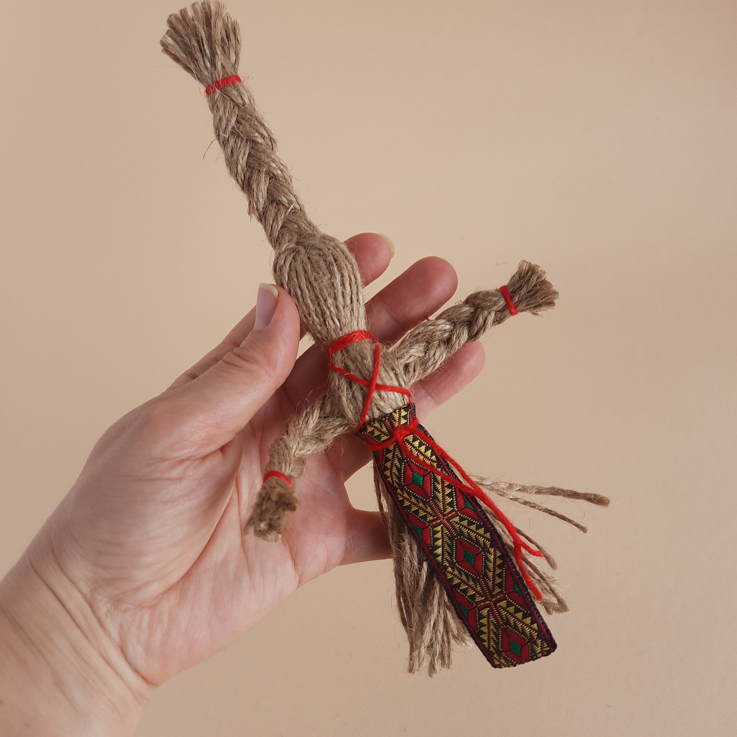Handmade Miniature Motanka Doll made from jute twine, showcasing traditional Ukrainian folk art and rustic charm in a hand.