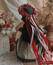 Handmade Ukrainian Motanka Doll with colorful ribbons and floral wreath on display, symbolizing Slavic folklore and protection.