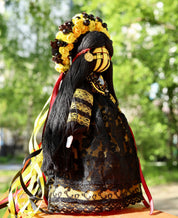 Handmade Ukrainian Motanka Doll in traditional attire, symbol of Slavic folklore and protection, with vibrant floral headdress.
