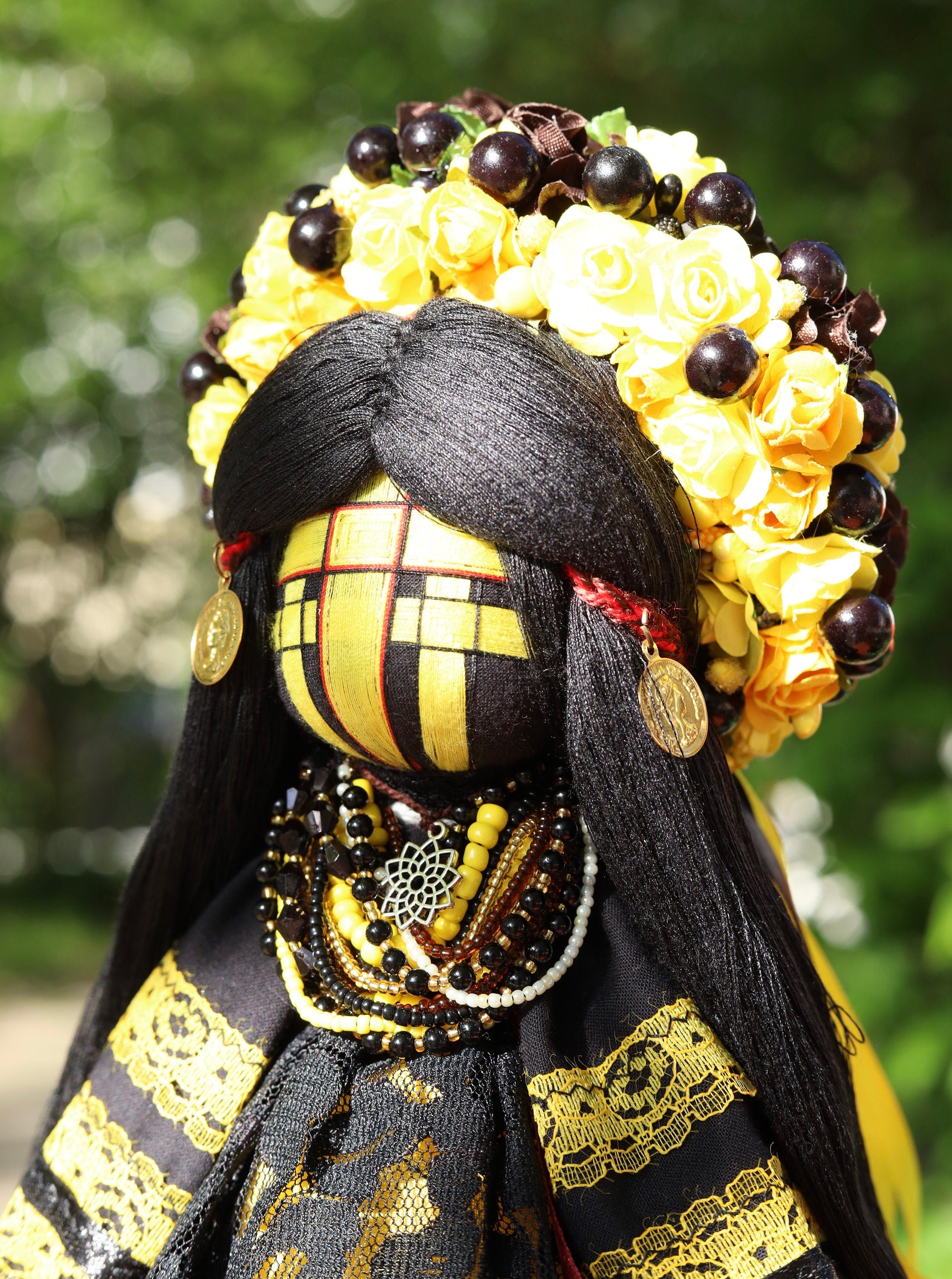 Traditional Ukrainian Motanka Doll with Floral Headdress and Beaded Necklace, Symbol of Protection and Good Fortune in Slavic Folklore