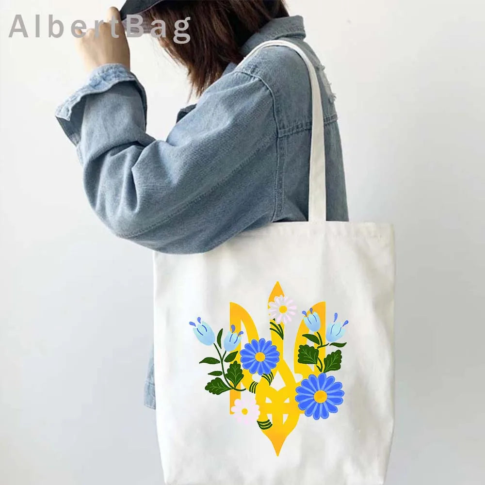 Ukrainian patriotic tote bag with floral design on a woman's shoulder