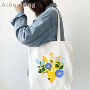 Ukrainian patriotic tote bag with floral design on a woman's shoulder