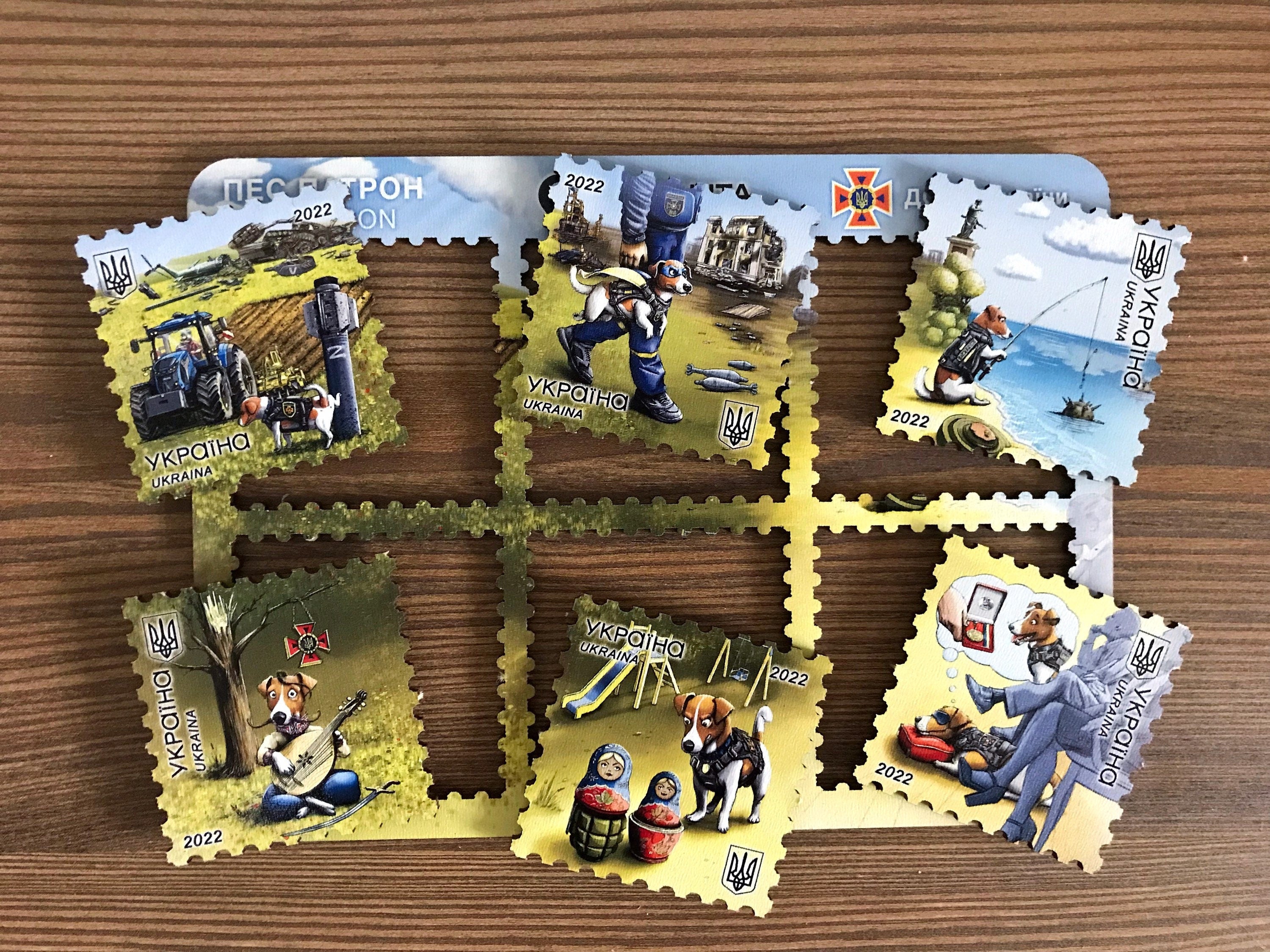 Set of 6 vibrant "Patron" Ukrainian postage stamp fridge magnets, celebrating the heroic Jack Russell terrier Patron.