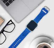 "Stand with Ukraine blue silicone Apple Watch band with Ukrainian emblem and engraved message on desk setting"