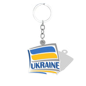Ukrainian flag keychain with blue and yellow design, featuring the word "Ukraine" in bold letters, symbolizing national pride.