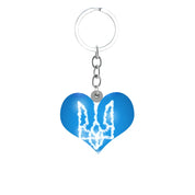 Heart-shaped Ukrainian Trident pendant keychain in blue and white, symbolizing pride and unity.