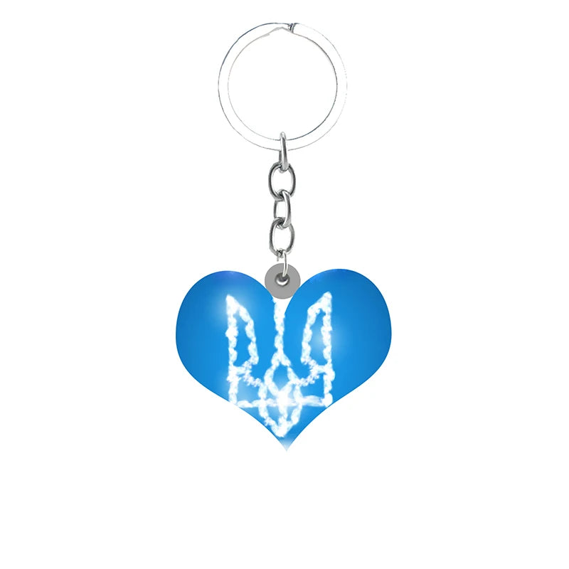 Heart-shaped Ukrainian Trident pendant keychain in blue and white, symbolizing pride and unity.