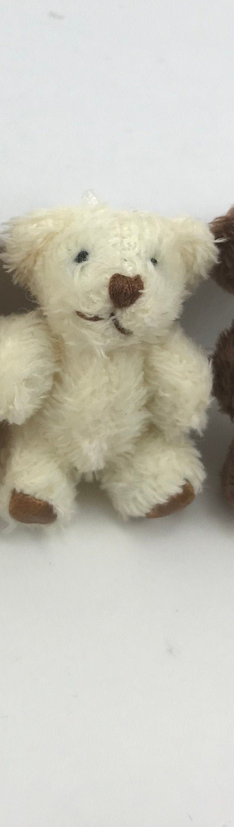 Cute hand-sewn tiny stuffed teddy bear with soft, fuzzy fabric, featuring moveable arms and legs, perfect for hanging decoration.