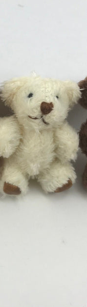 Cute hand-sewn tiny stuffed teddy bear with soft, fuzzy fabric, featuring moveable arms and legs, perfect for hanging decoration.