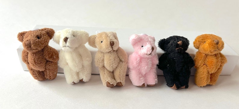 Miniature hand-sewn fuzzy teddy bears in assorted colors with movable arms and legs, perfect as cute hanging decorations.