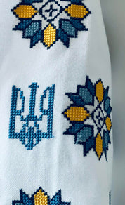 Ukrainian Vyshyvanka dress embroidery featuring Tryzub symbol and floral design in blue and yellow
