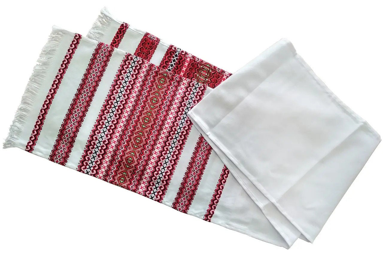 Traditional Ukrainian rushnyk with red-black Slavic embroidery, symbolizing unity and prosperity, perfect for weddings and decor.