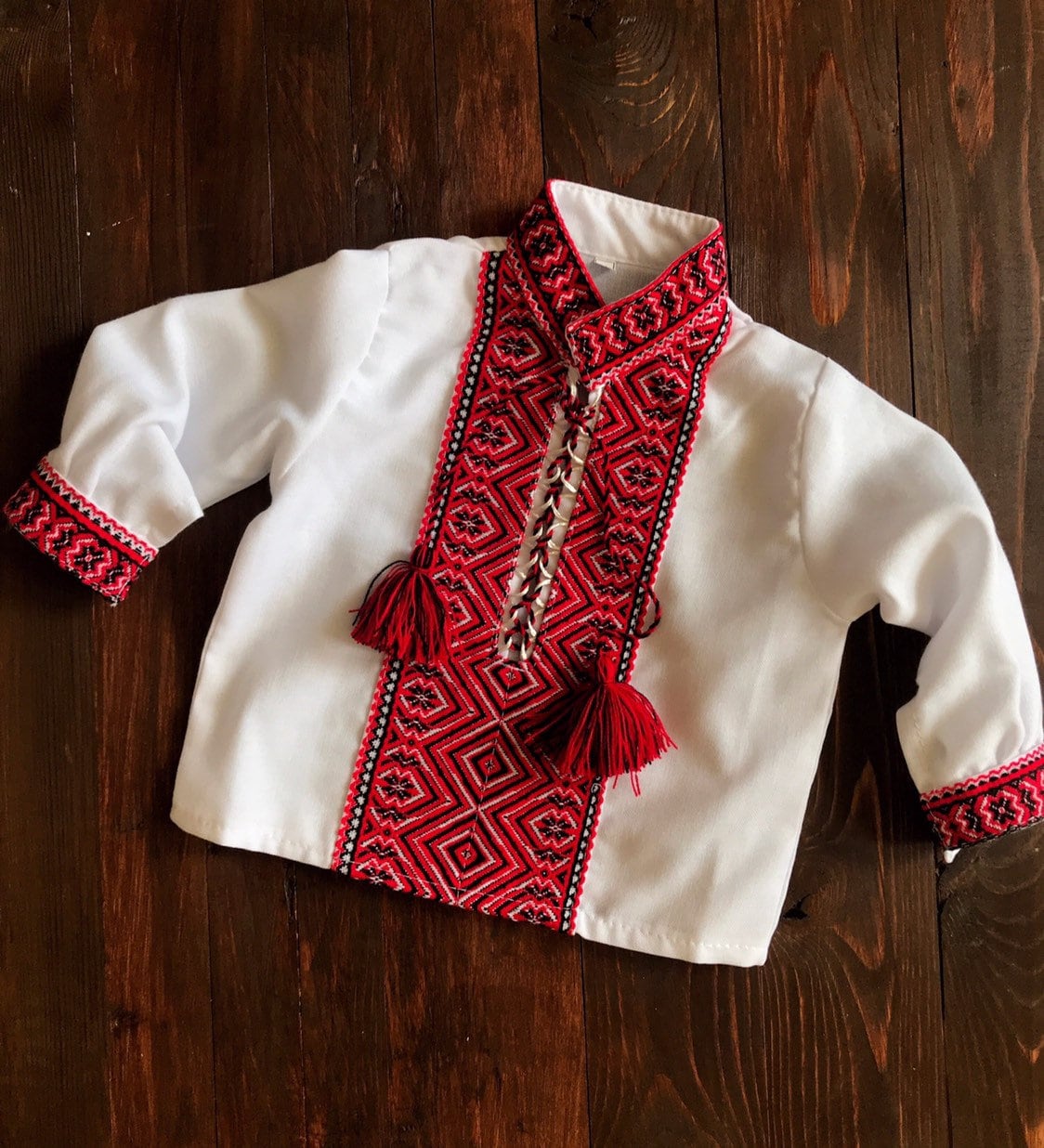 Traditional Ukrainian baby bodysuit with red embroidery, perfect for cultural events and celebrations. Soft cotton vyshyvanka design.