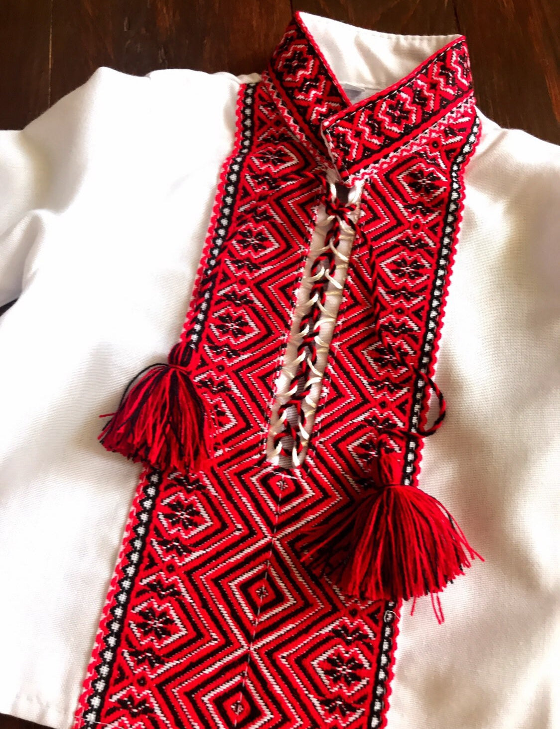 Ukrainian baby Vyshyvanka bodysuit with intricate red embroidery, perfect for cultural events and celebrations.