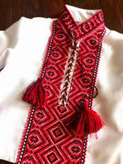 Ukrainian baby Vyshyvanka bodysuit with intricate red embroidery, perfect for cultural events and celebrations.