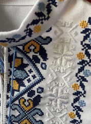 Close-up of boys' embroidered Ukrainian vyshyvanka shirt with blue and yellow Tryzub design