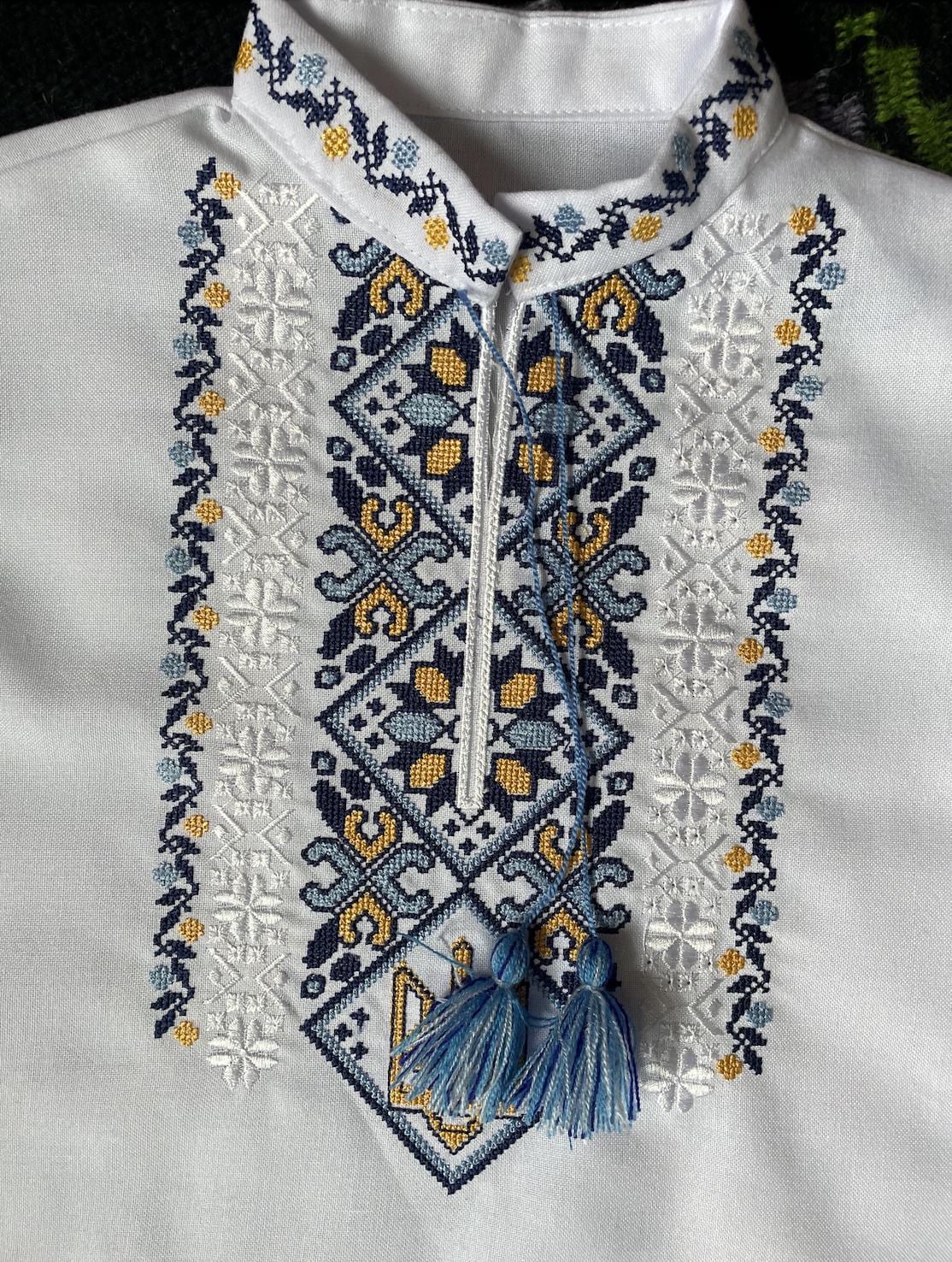 Ukrainian boy vyshyvanka shirt with Tryzub embroidery in blue and yellow, showcasing cultural heritage and cotton comfort.