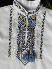 Ukrainian boy vyshyvanka shirt with Tryzub embroidery in blue and yellow, showcasing cultural heritage and cotton comfort.