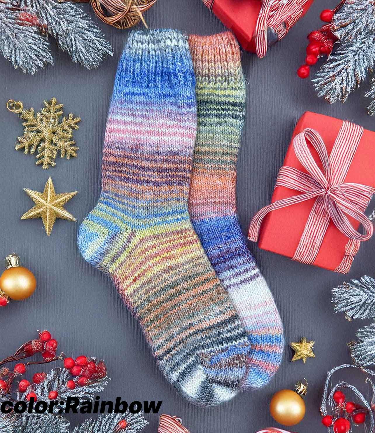 Colorful hand knitted wool socks with a rainbow pattern, surrounded by Christmas gifts and decorations, perfect cozy winter gift.