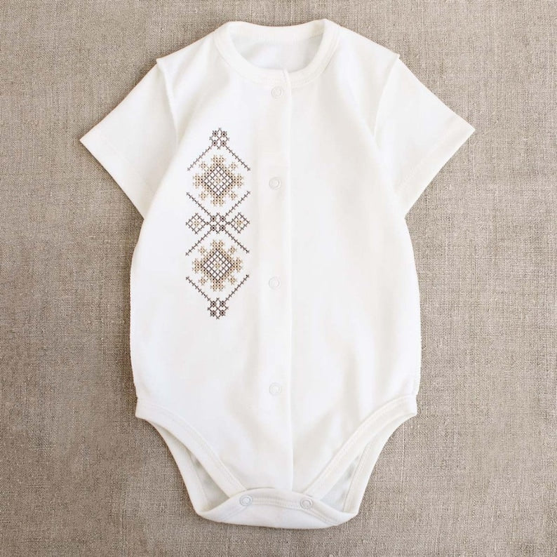 Ukrainian embroidered baby romper with beige-brown patterns, Vyshyvanka style, perfect for newborns and baby shower gifts.