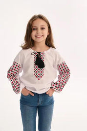 Girl wearing Ukrainian embroidered blouse with traditional Vyshyvanka patterns, celebrating Slavic folk art and cultural heritage.