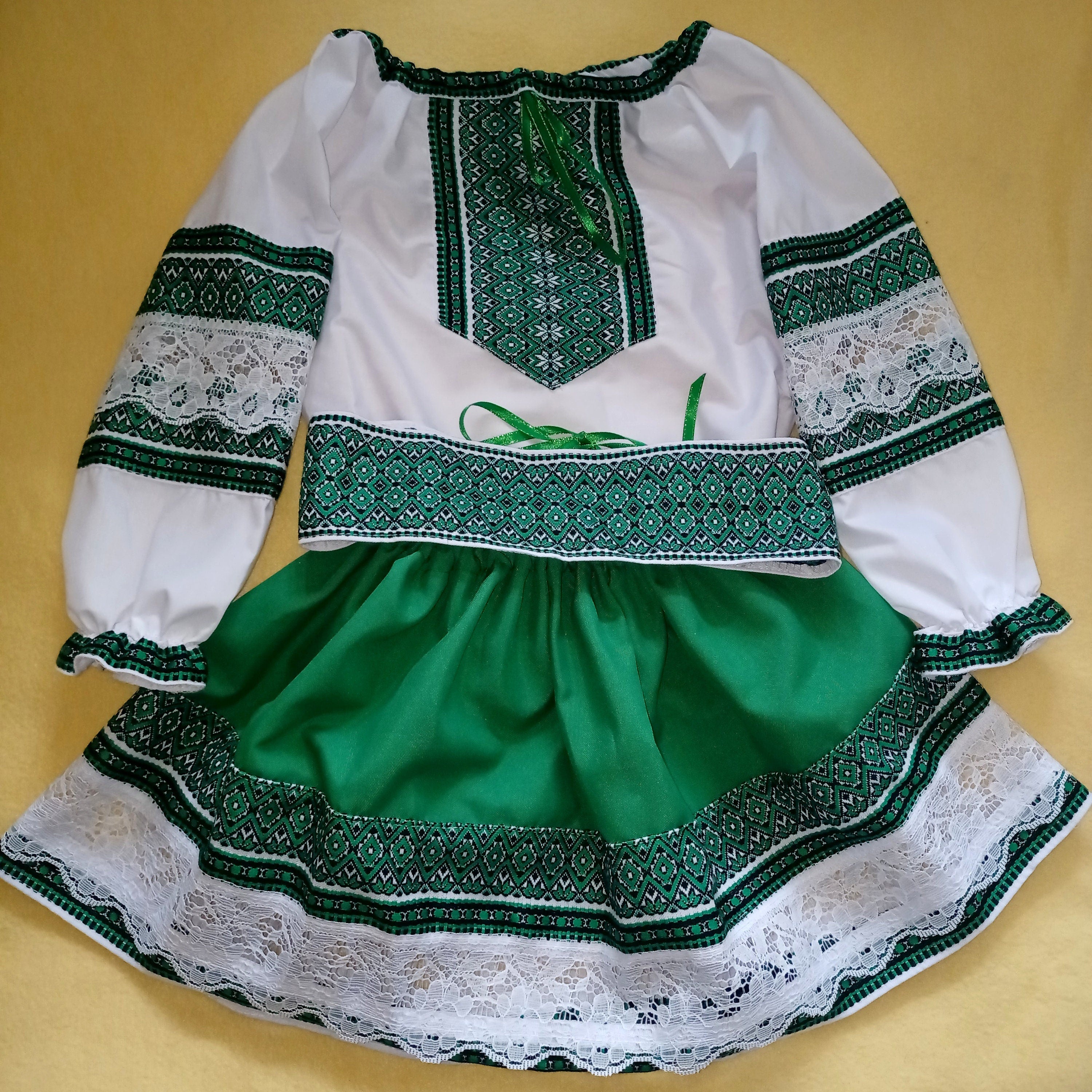 Green and white Ukrainian embroidered blouse and skirt set with traditional patterns for girls, featuring intricate lace details.
