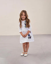 Young girl wearing a Ukrainian embroidered dress with floral patterns, traditional vyshyvanka style for cultural celebrations.
