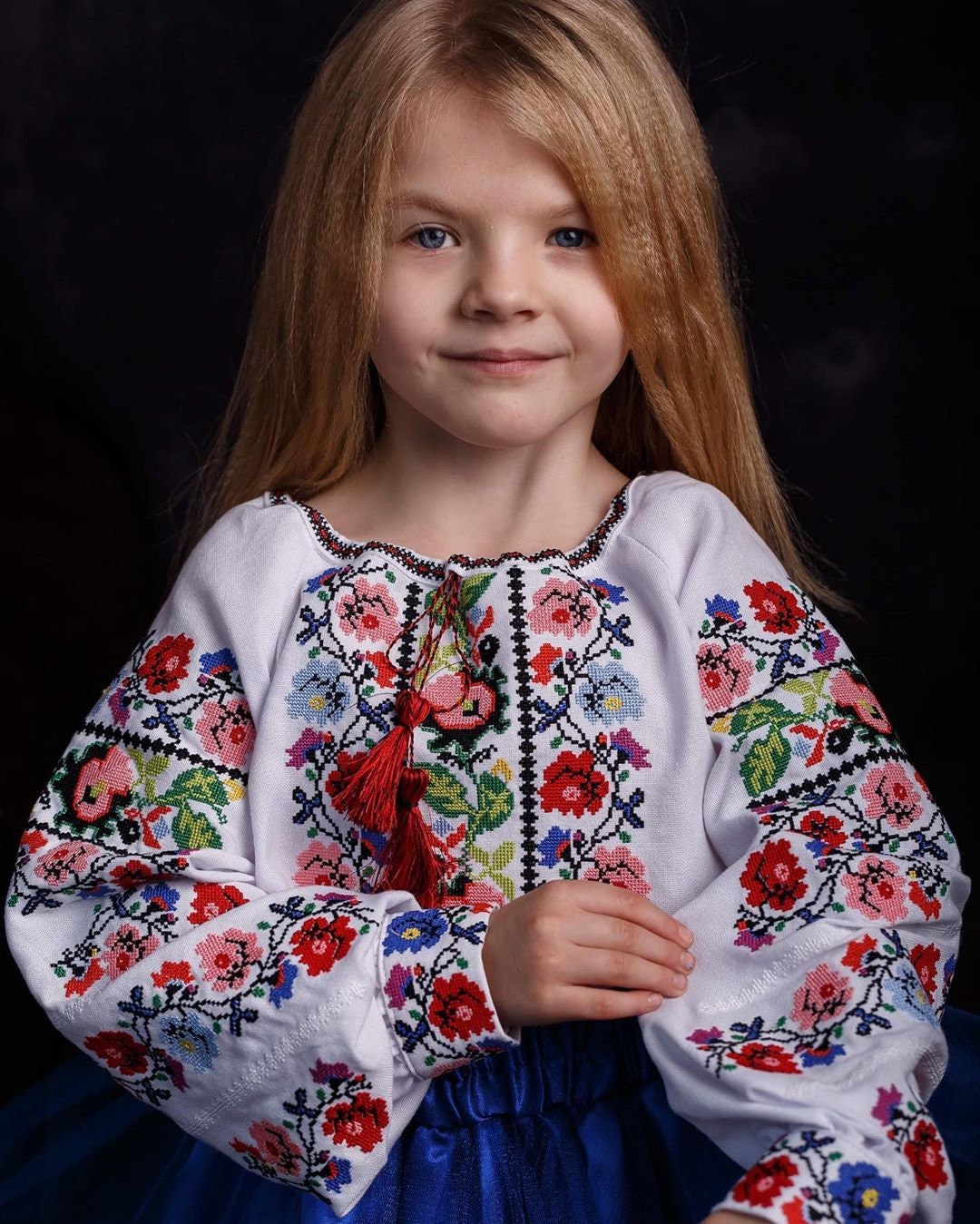 Young girl wearing a traditional Ukrainian embroidered Vyshyvanka blouse with floral design, perfect for cultural events.