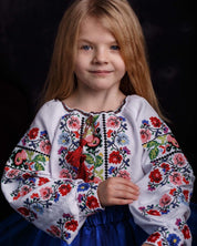 Young girl wearing a traditional Ukrainian embroidered Vyshyvanka blouse with floral design, perfect for cultural events.