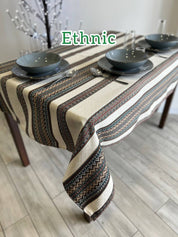 Ukrainian embroidered linen tablecloth with ethnic patterns on rectangular dining table.