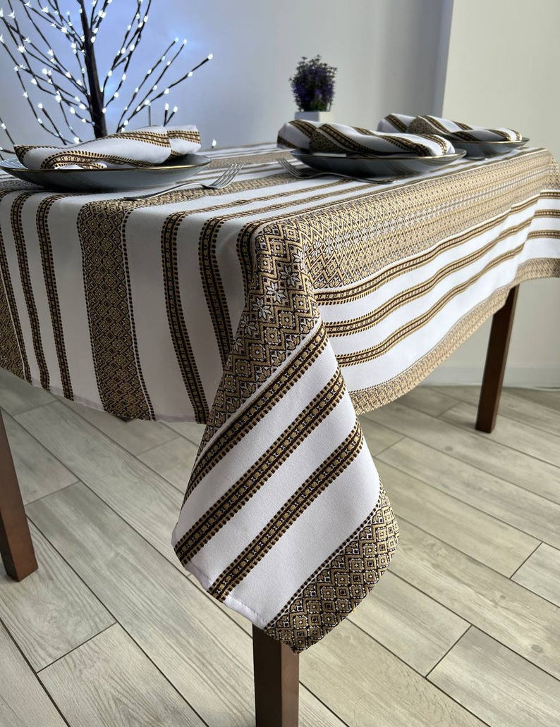 Ukrainian embroidered linen tablecloth with ethnic patterns on a dining table, made from 100% natural fabric, enhancing home decor.