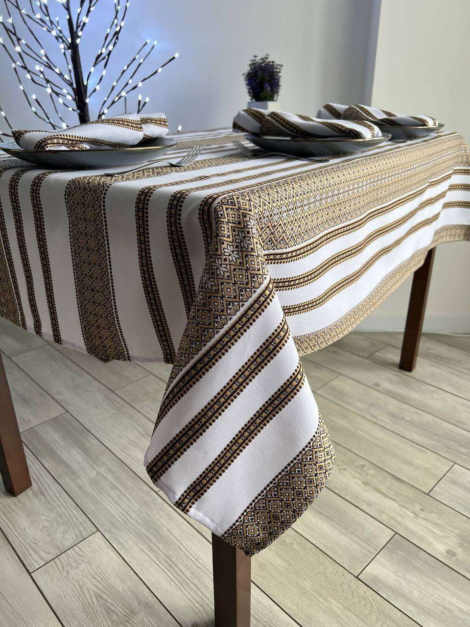 Ukrainian embroidered linen tablecloth with ethnic patterns on dining table.