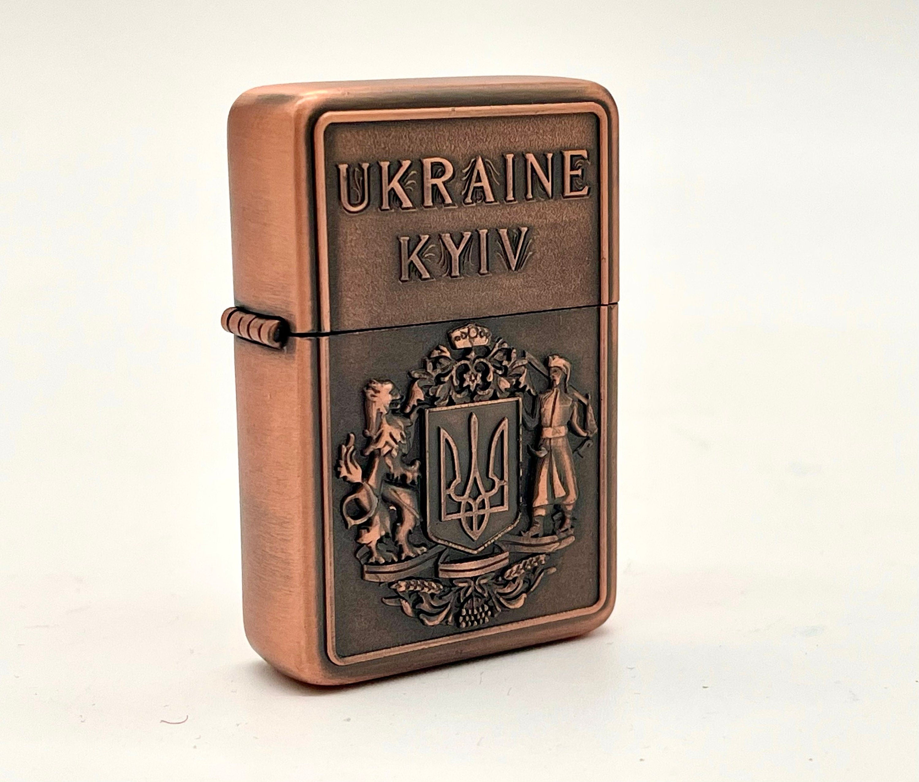 Ukrainian gasoline lighter with bronze coat of arms, featuring Kyiv inscription, collectible item showcasing national pride.