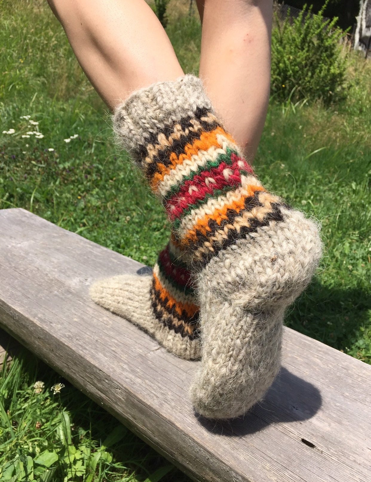 Handmade wool socks from Ukraine featuring colorful patterns, perfect for warmth and natural foot massage.