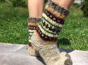 Hand knitted wool socks with colorful patterns, made in Ukraine, providing warmth and natural foot massage, ideal gift for loved ones.