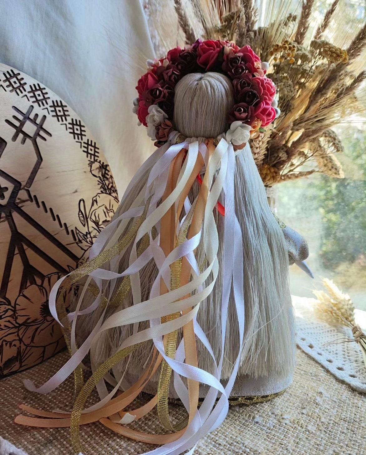 Handmade Motanka doll with floral crown, traditional Ukrainian talisman for protection and prosperity.