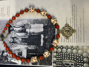 Harmony of Nature necklace with white clay beads and jasper, displayed over a cultural text background.
