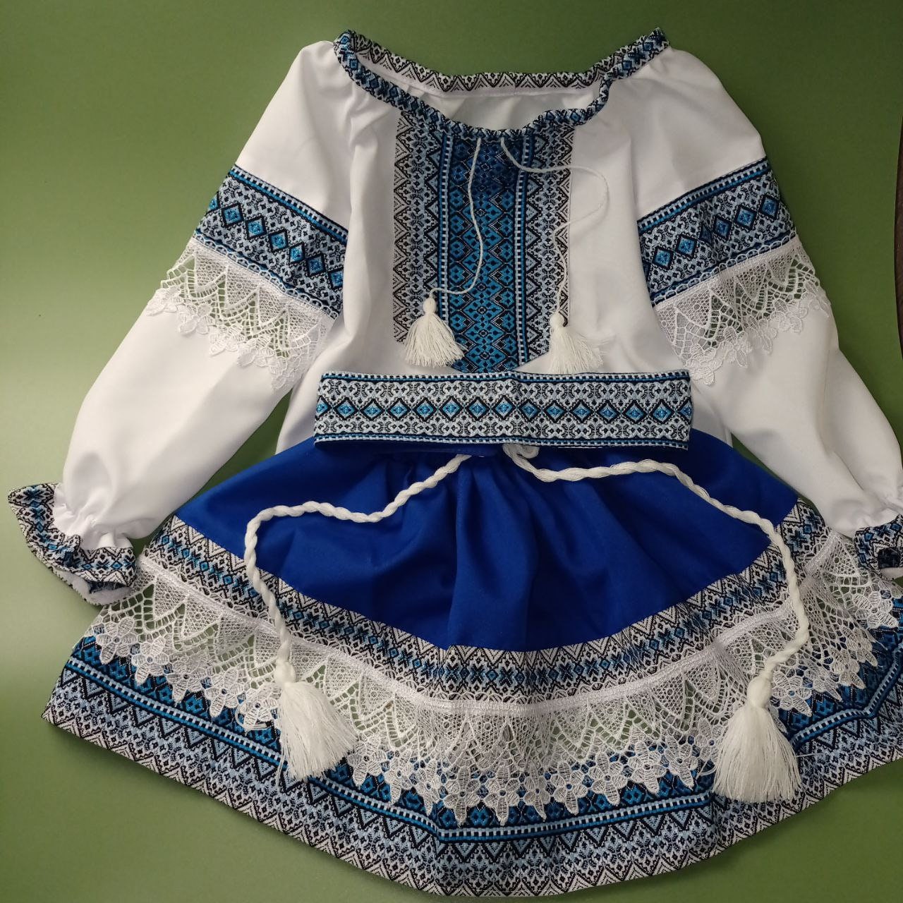 Ukrainian Hutsul Folk Costume for girls, blue woven set with lace; traditional three-piece outfit for cultural events and celebrations.