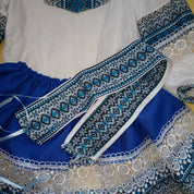 Ukrainian Hutsul folk costume for girls, featuring a blue woven blouse, lace skirt, and decorative belt for cultural events.